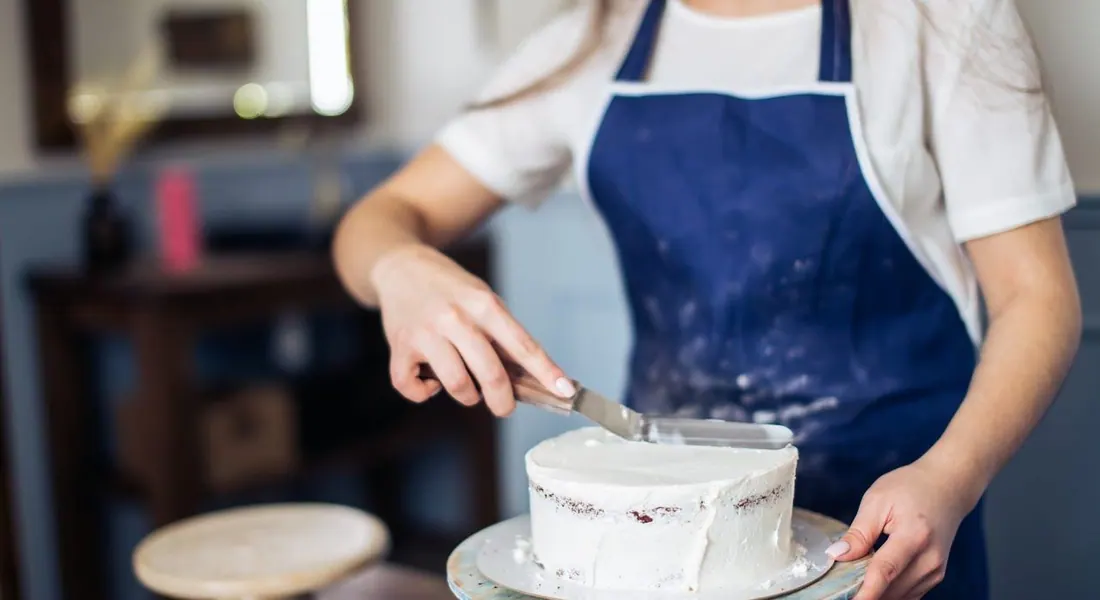 Frosting a cake in the kitchen